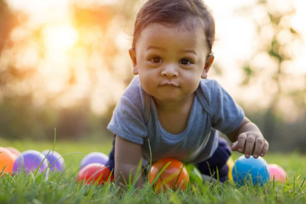 cute baby crawling in the grass