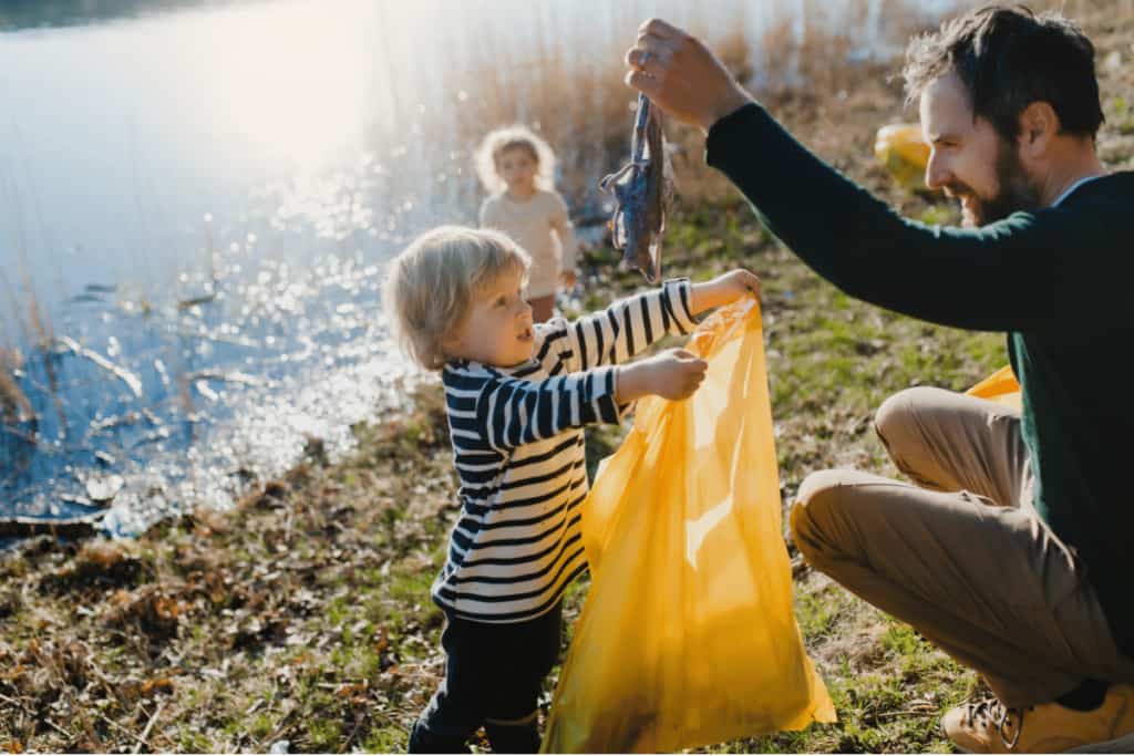 father son plogging picking up trash