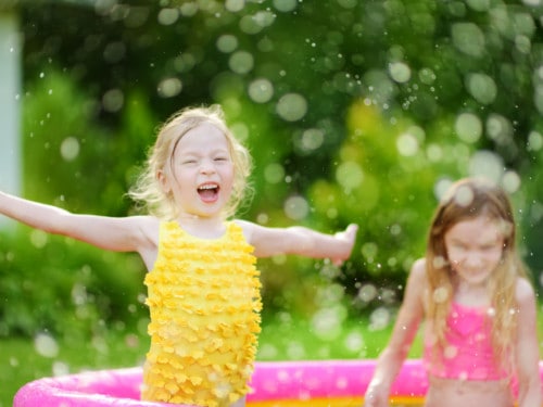 girl playing in the pool easy DIY summer activities for kids