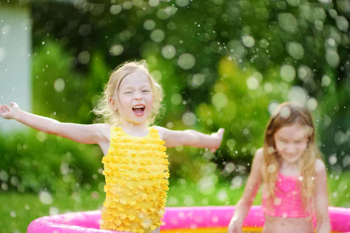 girl playing in the pool easy DIY summer activities for kids
