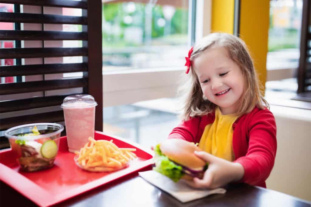 girl eating healthy fast food for kids
