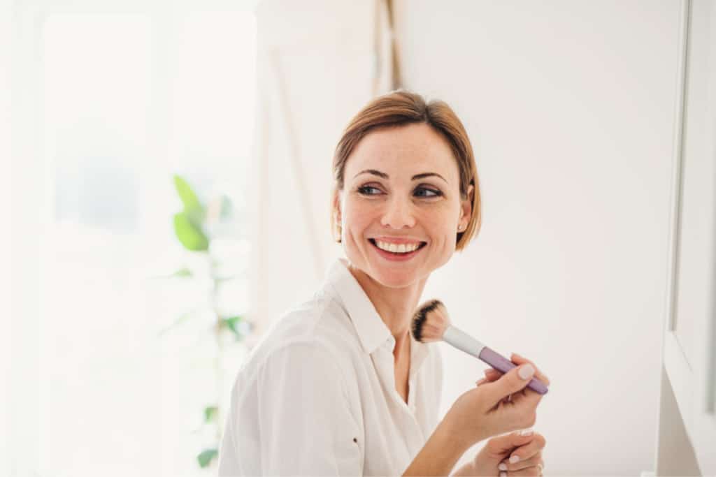 IT cosmetics woman putting on makeup
