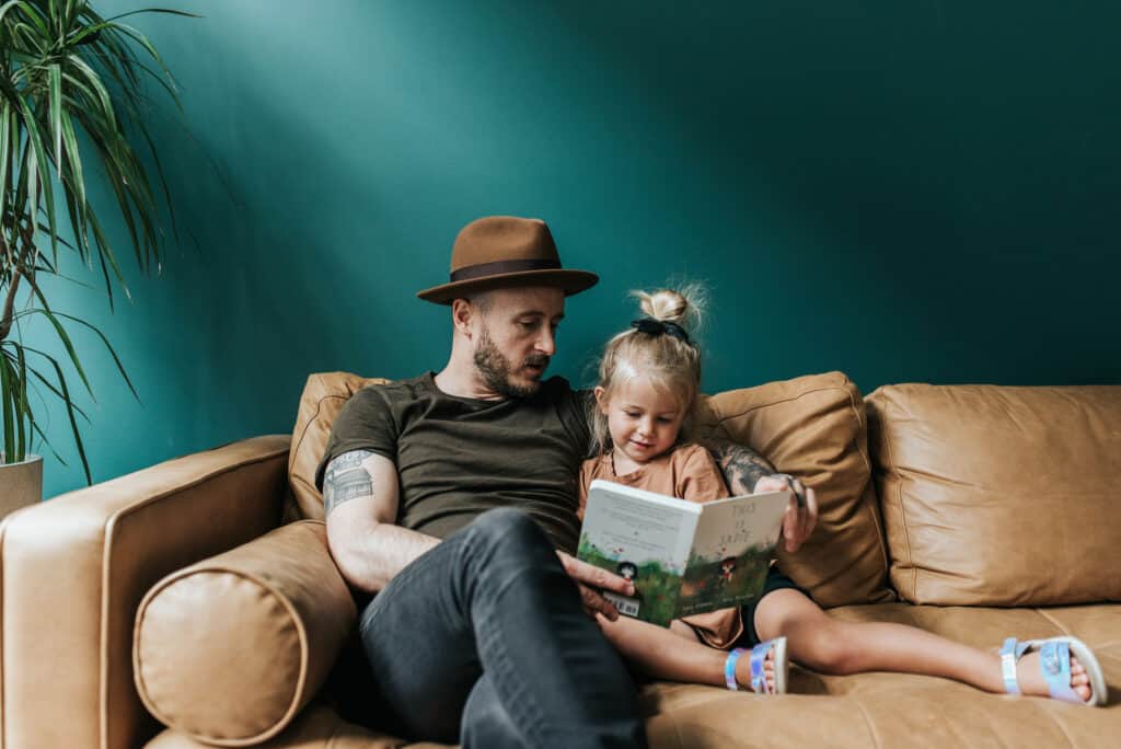 Refined Gritty dad on the street reading