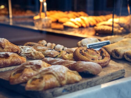 Close up of various pastries in a bakery window