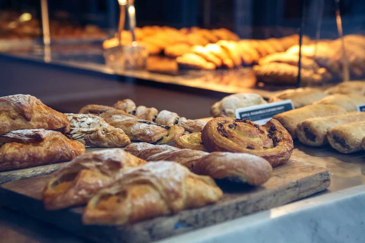 Close up of various pastries in a bakery window