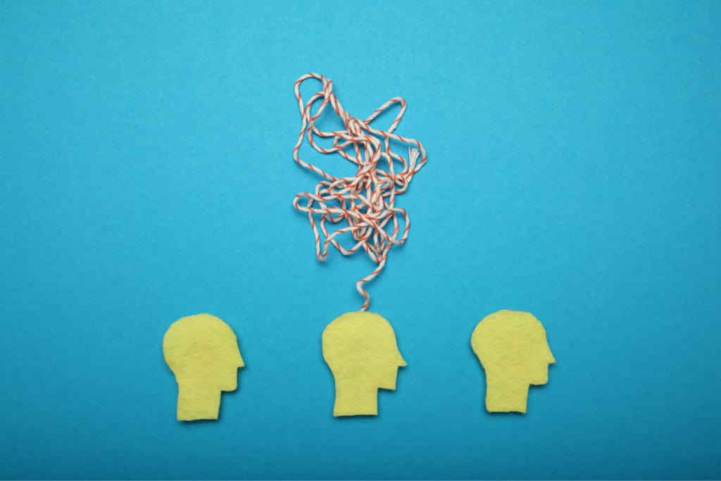 graphic for ADHD in wormen. Three silhouettes of human heads, one with a tangled string above it