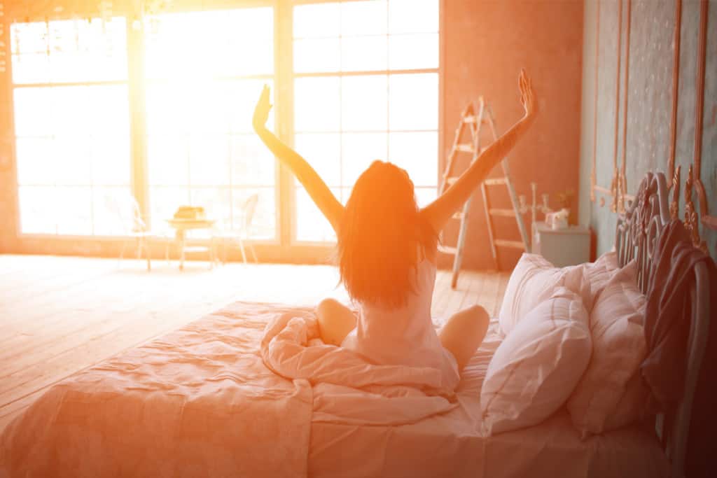 better sleep tips; woman waking up