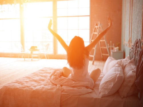 better sleep tips; woman waking up