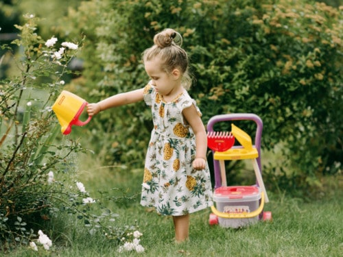 girl gardening in kids yard