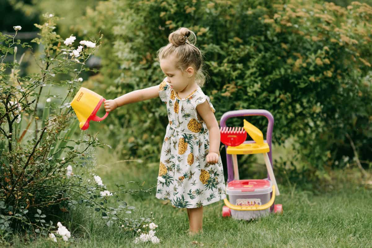 girl gardening in kids yard