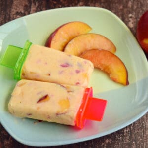 toddler desserts peaches and cream popsicles sit on a blue plate